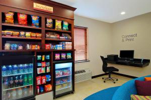 a store with a soda refrigerator and a desk in a room at Fairfield Inn & Suites Colorado Springs South in Colorado Springs