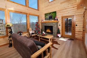a living room with a fireplace in a log cabin at Chestnut Tower in Gatlinburg