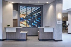 a lobby with a large painting on the wall at Delta Hotels by Marriott Detroit Novi in Farmington Hills +30 photos