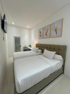 Postel nebo postele na pokoji v ubytování Graha Socio Hotel Nusa Dua Bali