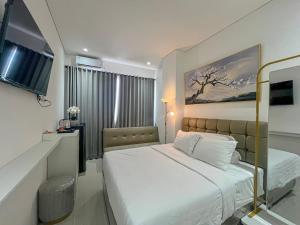Postel nebo postele na pokoji v ubytování Graha Socio Hotel Nusa Dua Bali
