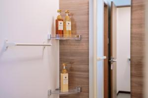 a room with three bottles of oils on a wall at Nihonbashi Royal in Osaka +238 photos