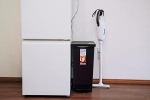 a white refrigerator next to a black and white object at Nihonbashi Royal in Osaka