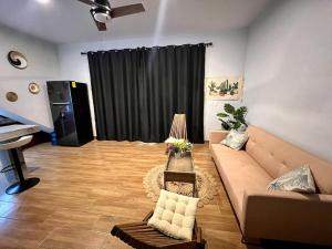 a living room with a couch and a piano at Casitas Punta Arenas #3 in La Ventana