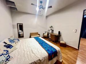 a bedroom with a bed and a desk in it at Casitas Punta Arenas #3 in La Ventana