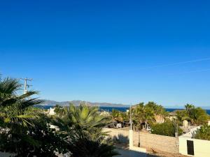 a view of the ocean from a building with palm trees at Casitas Punta Arenas #3 in La Ventana +9 photos