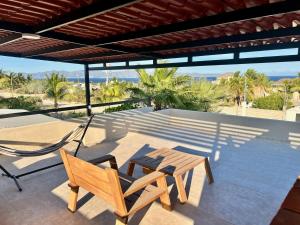 a patio with a table and a chair on a patio at Casitas Punta Arenas #3 in La Ventana