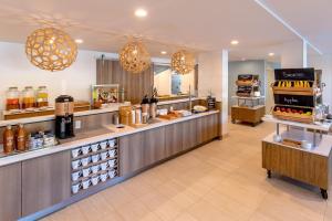 a restaurant with a counter with bottles of wine at Element Chelmsford in Chelmsford