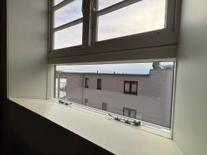 an open window with a view of a building at Pier 7 im Pierspeicher in Kappeln +5 photos