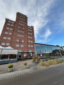 een groot gebouw van rode baksteen met veel ramen bij Pier 11 im Pierspeicher in Kappeln