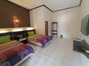 Yokima Beach Hotel 객실 침대