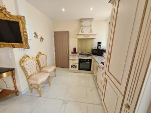 a kitchen with a table and two chairs and a television at Appartement Délire Baroque à Sully-sur-Loire avec Climatisation - FR-1-590-557 in Sully-sur-Loire