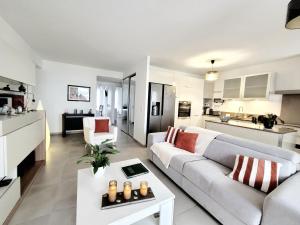 a living room with a couch and a table at T3 moderne avec clim et wifi, proche port et mer, box fermé - FR-1-794-157 in Canet-en-Roussillon