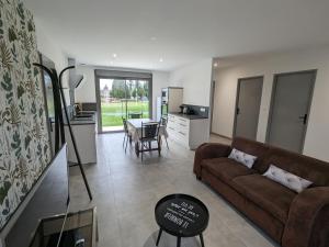 a living room with a couch and a table at Maison rénovée avec jardin et parking, proche Orléans, animaux acceptés - FR-1-590-561 in Épieds-en-Beauce