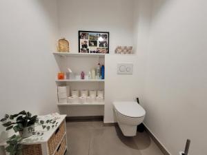 a white bathroom with a toilet and a shelf at T3 moderne avec clim et wifi, proche port et mer, box fermé - FR-1-794-157 in Canet-en-Roussillon +6 photos