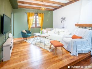 a living room with a white couch and a table at Villa spacieuse avec jardin, cheminée et billard, 5 chambres pour 10 pers. - FR-1-786-35 in Les Avirons