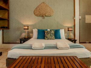 a large bed in a room with two lamps at Golden Monkey Beach Hotel in El Nido