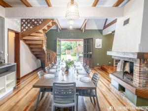 a dining room with a long table and a fireplace at Villa spacieuse avec jardin, cheminée et billard, 5 chambres pour 10 pers. - FR-1-786-35 in Les Avirons