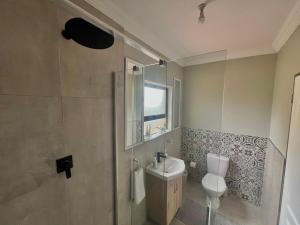 a bathroom with a toilet and a sink at The Cozy Nook @ Skyfall Country Estate in Polokwane