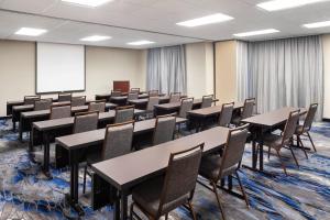 a conference room with tables and chairs and a whiteboard at Fairfield Inn & Suites Denver Airport in Denver +18 photos