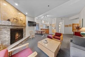 a living room with a couch and a fireplace at Palisades Tahoe Lodge Rentals Two Bedroom #521 in Olympic Valley