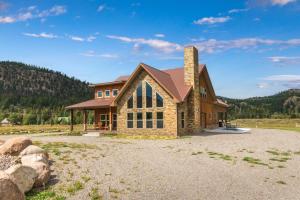a large stone house with a chimney at MountainAire in South Fork, CO in South Fork