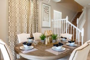 a dining room with a wooden table and white chairs at Modern 5BR TwnHome w Private Pool Near Disney 358 in Kissimmee