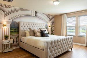 a bedroom with a large white bed with an ornate ceiling at Modern 5BR TwnHome w Private Pool Near Disney 358 in Kissimmee