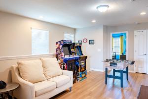 a living room with a couch and a video game at Modern 5BR TwnHome w Private Pool Near Disney 358 in Kissimmee +18 photos