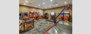 a room with several video game machines in it at Modern 5BR TwnHome w Private Pool Near Disney 358 in Kissimmee