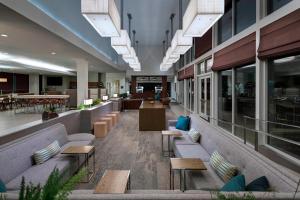 a lobby of a building with benches and tables at Element Houston Vintage Park in Houston