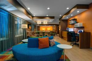 a living room with a blue couch and a table at Fairfield Inn & Suites by Marriott Fort Worth I-30 West Near NAS JRB in Fort Worth