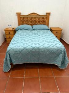 a bedroom with a bed and two night stands at casa los sabinos in Tepoztlán