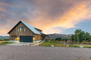 a barn with a garage on the side of a road at Rocking M Ranch in South Fork, CO in South Fork