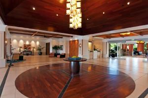 a large lobby with a wooden ceiling and a table in the middle at Oceanfront Views Above Dukes - Wrap Around Lanai - Outdoor Kitchen Honua Kai H351 in Lahaina +109 photos