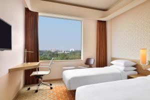 Postel nebo postele na pokoji v ubytování Fairfield by Marriott Chennai Mahindra World City