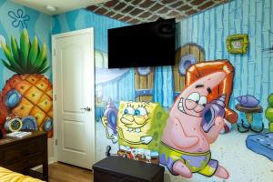 a bedroom with a cartoon mural on the wall at Modern 5BR TwnHome w Private Pool Near Disney 358 in Kissimmee
