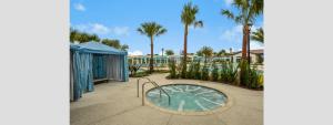 a view of a resort with palm trees at Modern 5BR TwnHome w Private Pool Near Disney 358 in Kissimmee