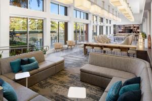 a lobby with couches and a table and chairs at Element Miami International Airport in Miami