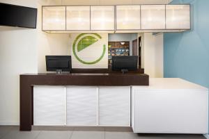 a reception desk with two monitors on top of it at Element Miami International Airport in Miami