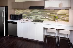 a white kitchen with a sink and a refrigerator at Element Miami International Airport in Miami