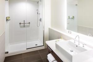a white bathroom with a sink and a shower at Element Miami International Airport in Miami