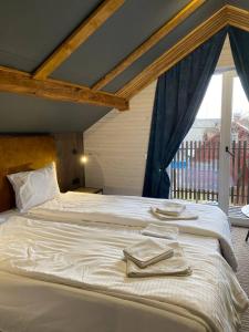 a large white bed with towels on top of it at MiShelter in Migovo +68 photos