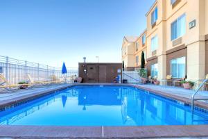 a swimming pool in front of a building at Fairfield Inn by Marriott Las Cruces in Las Cruces