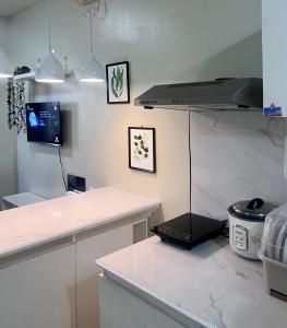 a kitchen with a counter and a laptop on the wall at 2 Bedroom Condo Unit with Balcony Amaia Steps Altaraza in Tunkong Manga