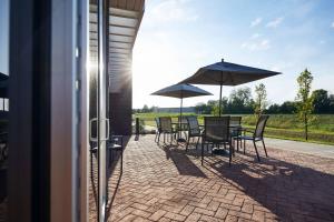 a patio with tables and chairs and umbrellas at Fairfield Inn & Suites by Marriott Kansas City Belton in Belton
