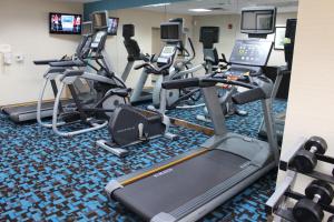 a gym with several treadmills and a row of exercise bikes at Fairfield Inn & Suites Kansas City Liberty in Liberty