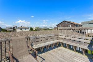 a wooden bench and two chairs on a deck at 7141 - Geri's Place #9 in Wanchese