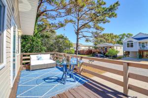 a patio with a table and a couch on a deck at 5041 - The Captains Quarters in Kill Devil Hills