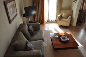 a living room with a couch and a coffee table at Philoxenia in Kavála